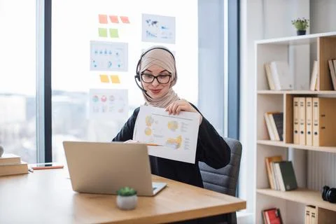 Lady in headset analysing data in charts on web conference Stock Photos