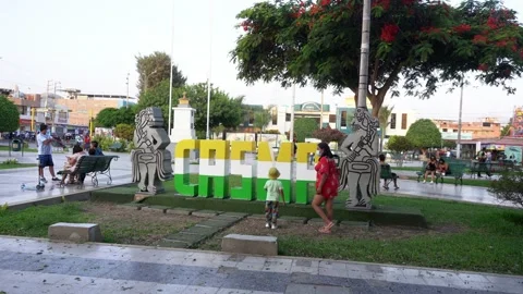 A lady with her son in the central square of Casma - Casma, Peru - April 2022 Stock Footage 196737299