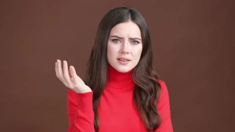Lady hesitate difficult question remember isolated brown color background Stock Footage 189495907