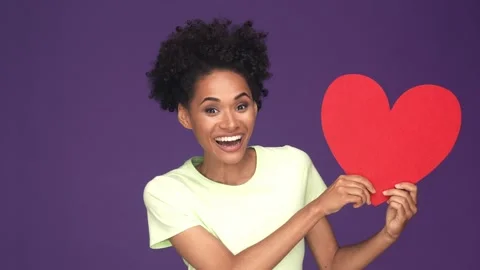 Lady hold large card red heart impressed isolated purple color background Stock Footage 165879356