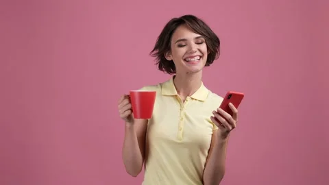 Lady hold latte chilling use gadget isolated pastel color background Stock Footage 169026405