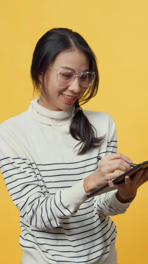 Lady holding tablet computer and pointing finger up at copy space enjoy. 動画素材 347202638