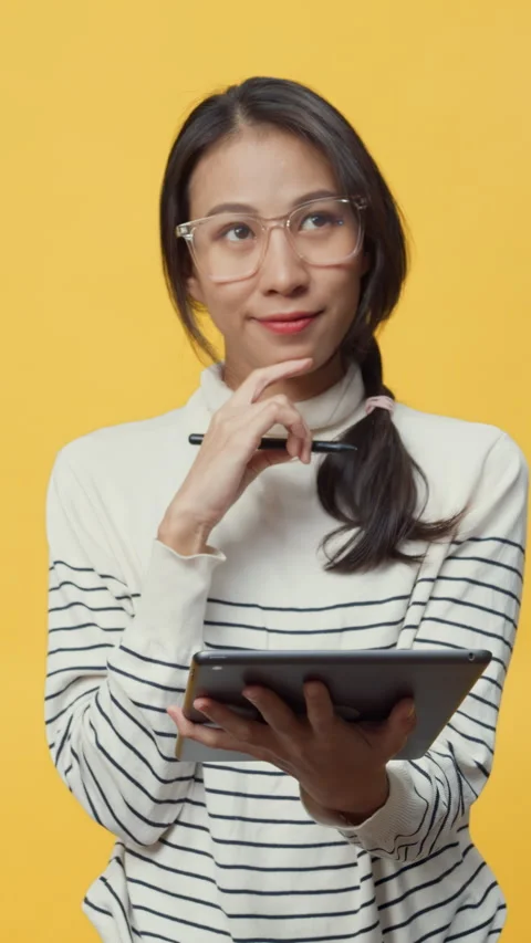 Lady holding tablet computer and pointing finger up at copy space. 動画素材 347202750