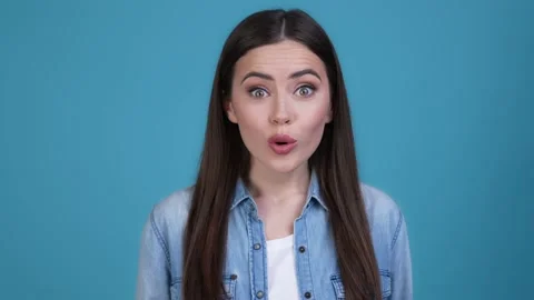 Lady impressed incredible message look isolated blue color background Stock Footage 168611643
