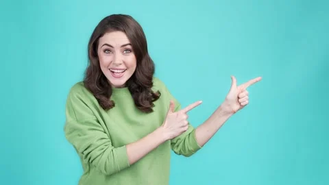 Lady impressed promo ads point empty space isolated cyan color background Stock Footage 169942971