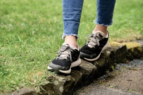 A lady is jogging on narrow path after wearing new shoes Stock Photos