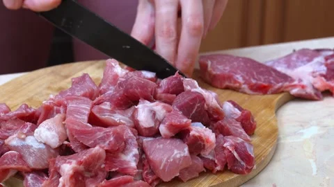 Lady In Kitchen Exhibits Exceptional Proficiency In Slicing Meat Accurately Stock Footage 329063236