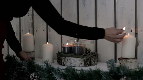 A lady lights candles. The warmth and atmosphere of the Xmas holiday 스톡 동영상 99201715