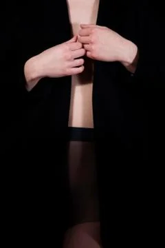 Lady in long coat posing in studio, body detail, erotic concept Stock Photos