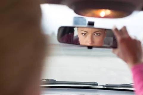 Lady looking back while reversing. Stock Photos