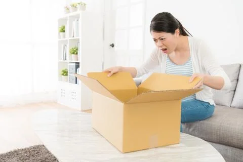 Lady looking at her parcel box feeling unhappy Photos