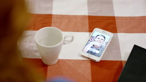 Lady looks at vibrating smartphone and ignores incoming call Stock Footage 229845290