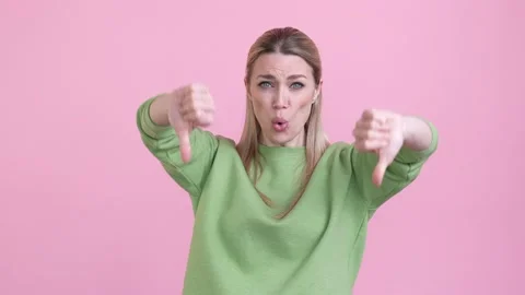 Lady make thumb down symbol not like ads isolated pastel color background Video stock 169864501