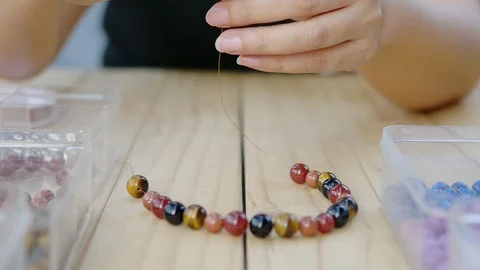 Lady making beats necklace Stock Footage 100793878