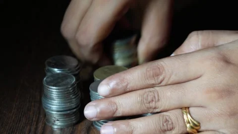 The lady is making stacks of coins Stock Footage 314613289