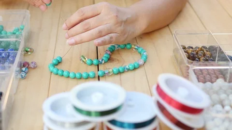 Lady making turquoise necklace Video stock 100796956