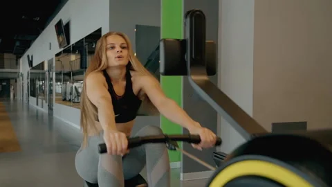Lady making workout in gym with modern machine Stock Footage 109408976