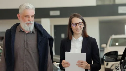 Lady manager with documents in hand walks with senior client Spbi Stock Footage 155274026