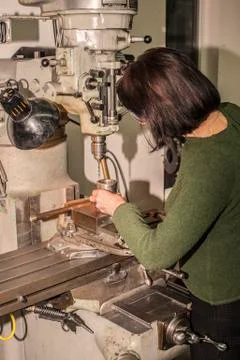 Lady manual mill operator at work. Machine, manufacturing. Stock Photos