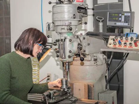 Lady manual mill operator at work. Caucasian, engineering. Stock Photos