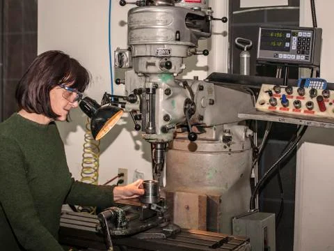 Lady manual mill operator at work. Caucasian, engineering. Stock Photos