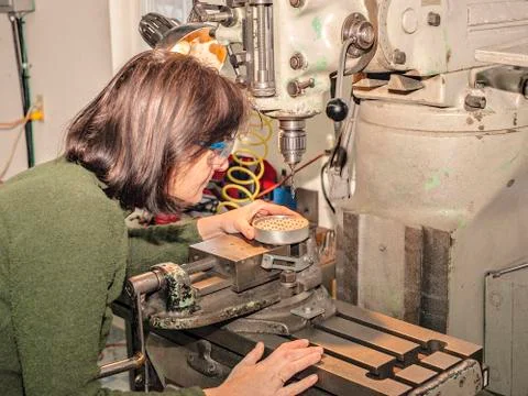 Lady manual mill operator at work. Caucasian, engineering. Stock Photos