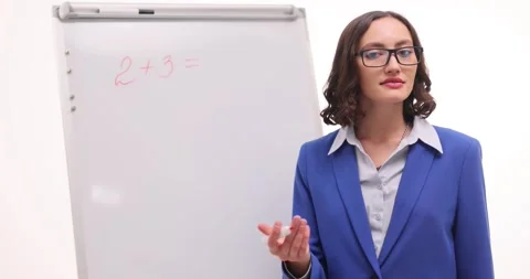 Lady math teacher explains steps for solving simple problem Stock Footage 294314087