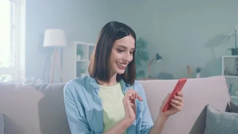 Lady millennial sit divan use gadget search web sale thoughts in apartment Video stock 166216280