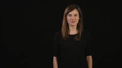 A Lady Mimicing Against a Black Background Stock Footage 87158280