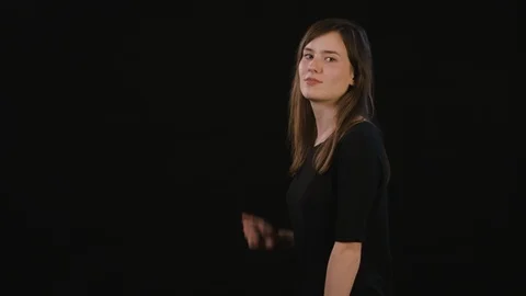 A Lady Mimicing Against a Black Background Stock Footage 87159705