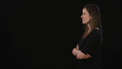 A Lady Mimicing Against a Black Background Stock Footage 87161445