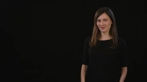 A Lady Mimicing Against a Black Background Stock Footage 87162603