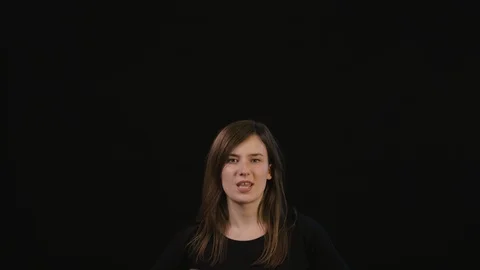 A Lady Mimicing Against a Black Background Stock Footage 87163556