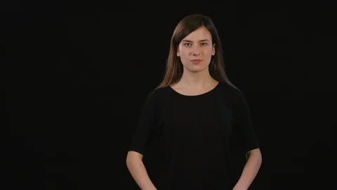 A Lady Mimicing Against a Black Background Stock Footage 87164907