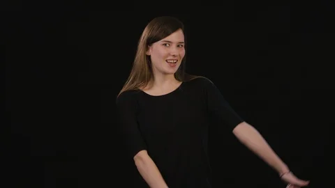 A Lady Mimicing Against a Black Background Stock Footage 87165848