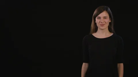 A Lady Mimicing Against a Black Background Stock Footage 87166356