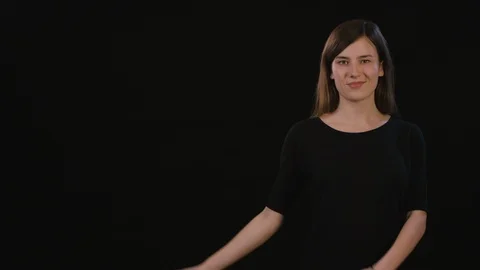 A Lady Mimicing Against a Black Background Stock Footage 87166517