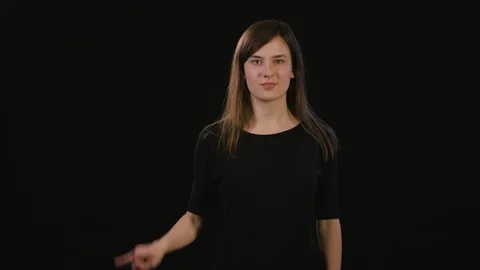 A Lady Mimicing Against a Black Background Stock Footage 87170068
