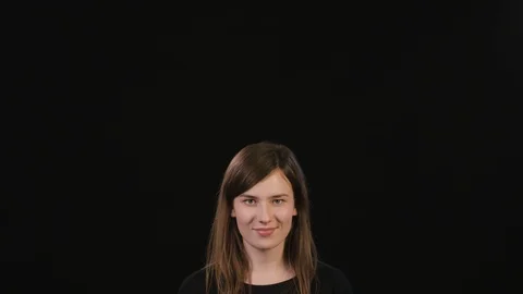 A Lady Mimicing Against a Black Background Stock Footage 87178969