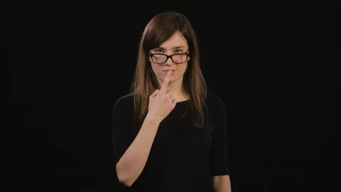 A Lady Mimicing Against a Black Background Stock Footage 87181980
