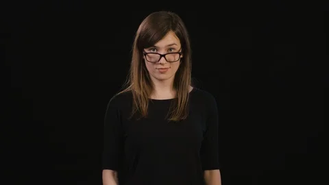 A Lady Mimicing Against a Black Background Stock Footage 87182255