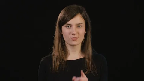 A Lady Mimicing Against a Black Background Stock Footage 87184218
