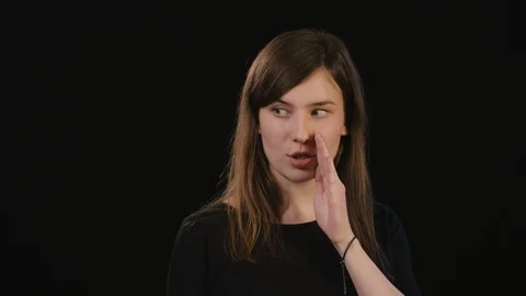 A Lady Mimicing Against a Black Background Stock Footage 87184489