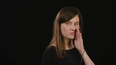 A Lady Mimicing Against a Black Background Stock Footage 87184730