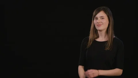 A Lady Mimicing Against a Black Background Stock Footage 87184838