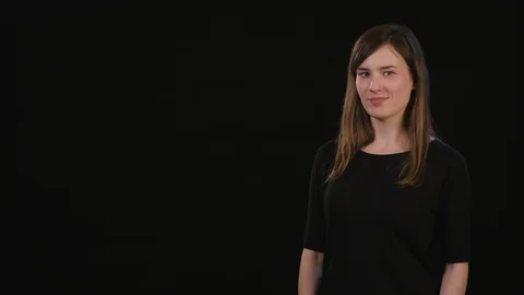 A Lady Mimicing Against a Black Background Stock Footage 87184980