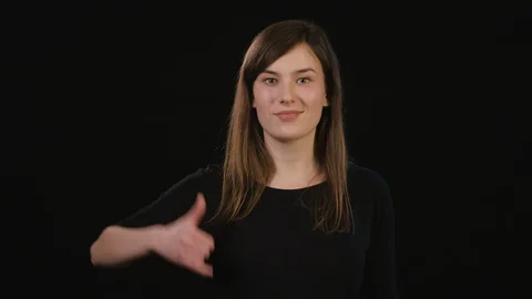 A Lady Mimicing Against a Black Background Stock Footage 87185248