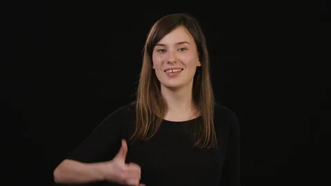 A Lady Mimicing Against a Black Background Stock Footage 87185364