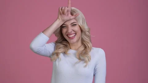 Lady mock point camera fingers forehead isolated pastel color background Stock Footage 167544612