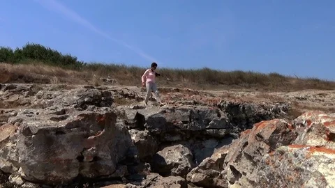 Lady model walking on the edge of sea cliffs kaliakra yaylata bulgaria Stock Footage 71194559